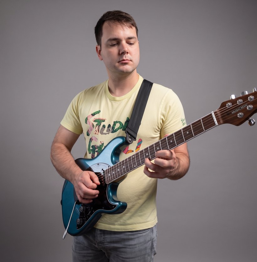 Steven Converse playing guitar in the studio